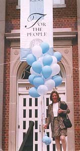 SILS alumna Deborah Basalmo with balloons outside Manning Hall
