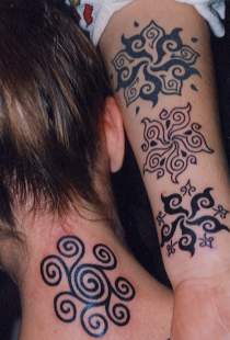 neck and are covered with tattoo designs